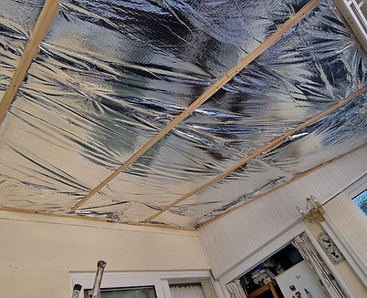 Silver back insulation being installed on conservatory roof rafters