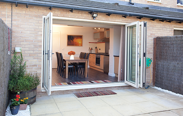 Aluminium bi-folding doors open to garden - bringing the outside in