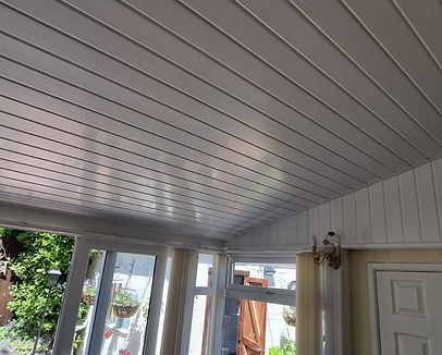 Finished conservatory roof insulation with white PVC cladding