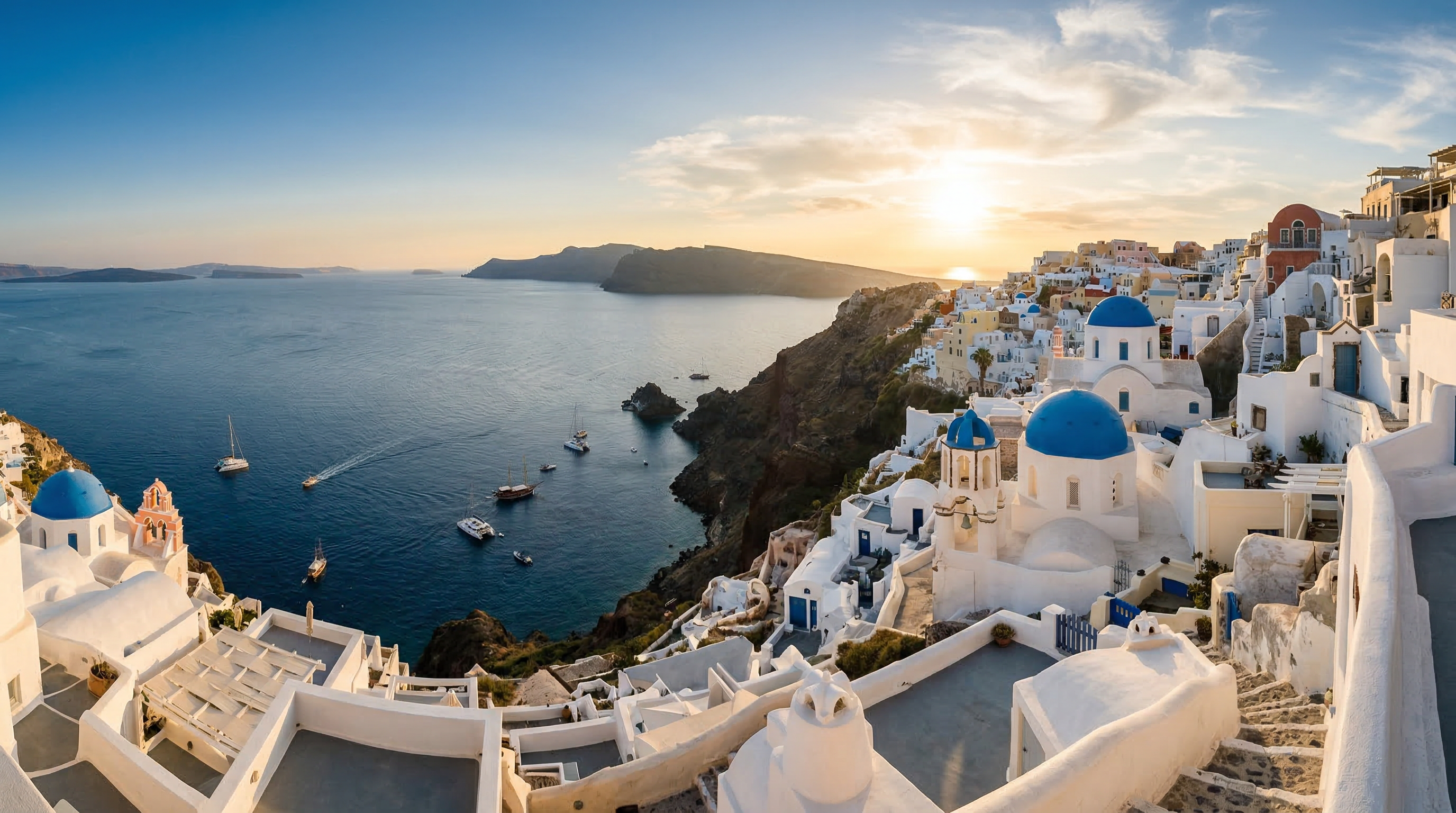 Santorini at golden hour with iconic blue-domed churches and caldera views