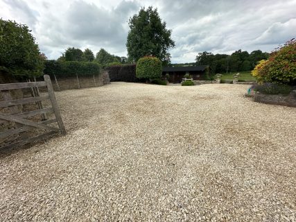 Gravel courtyard and landscaped garden at a country property