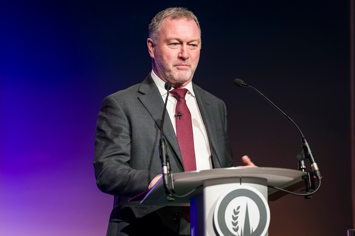 Speaker at podium on stage at the Oxford Farming Conference