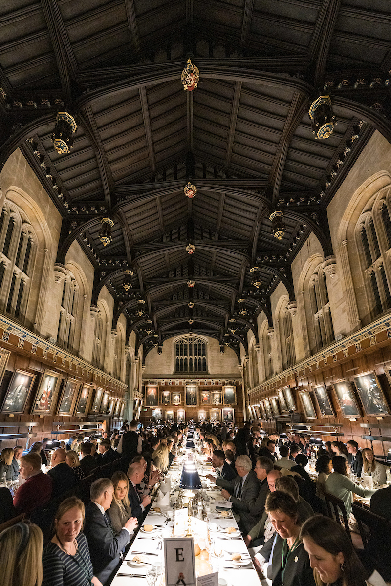 Grand historic banquet hall at Oxford Farming Conference with vaulted timber ceiling and communal dining tables