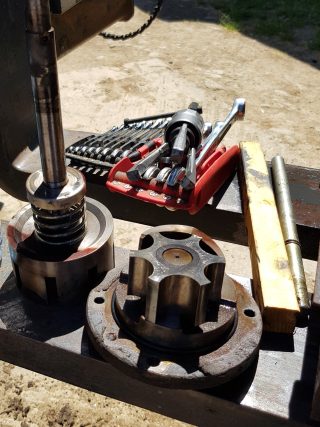 Machinery maintenance tools and metal components on a workbench