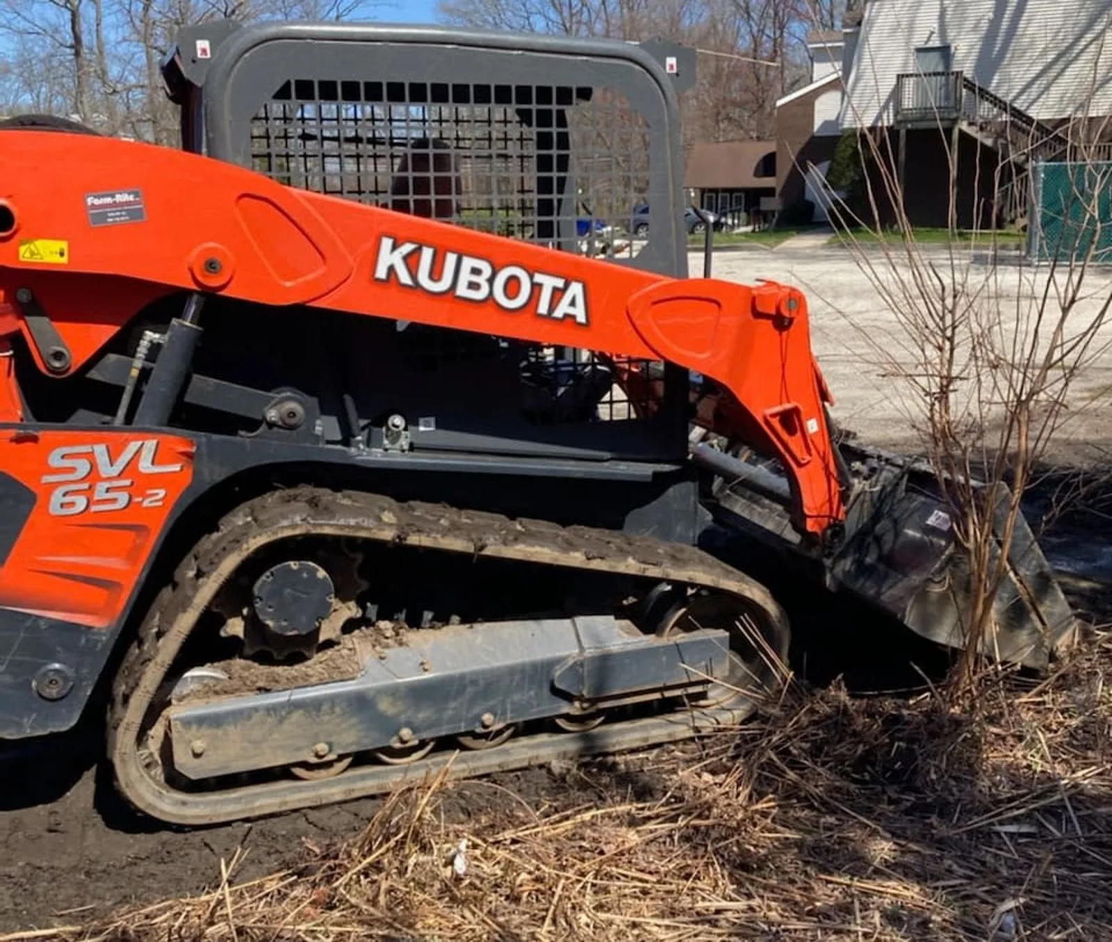Professional landscaping team performing seasonal services on a residential property