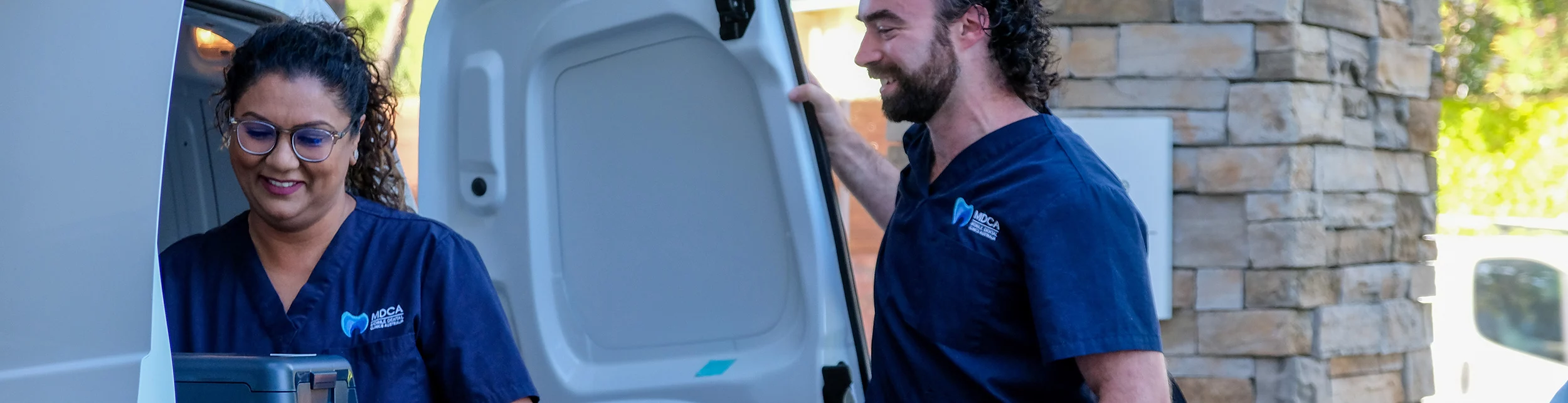 MDCA team with mobile dental van on-site at a facility