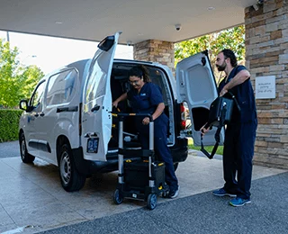 MDCA team unloading dental equipment from mobile clinic van