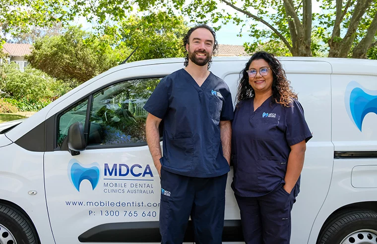 MDCA dental team beside their mobile clinic van