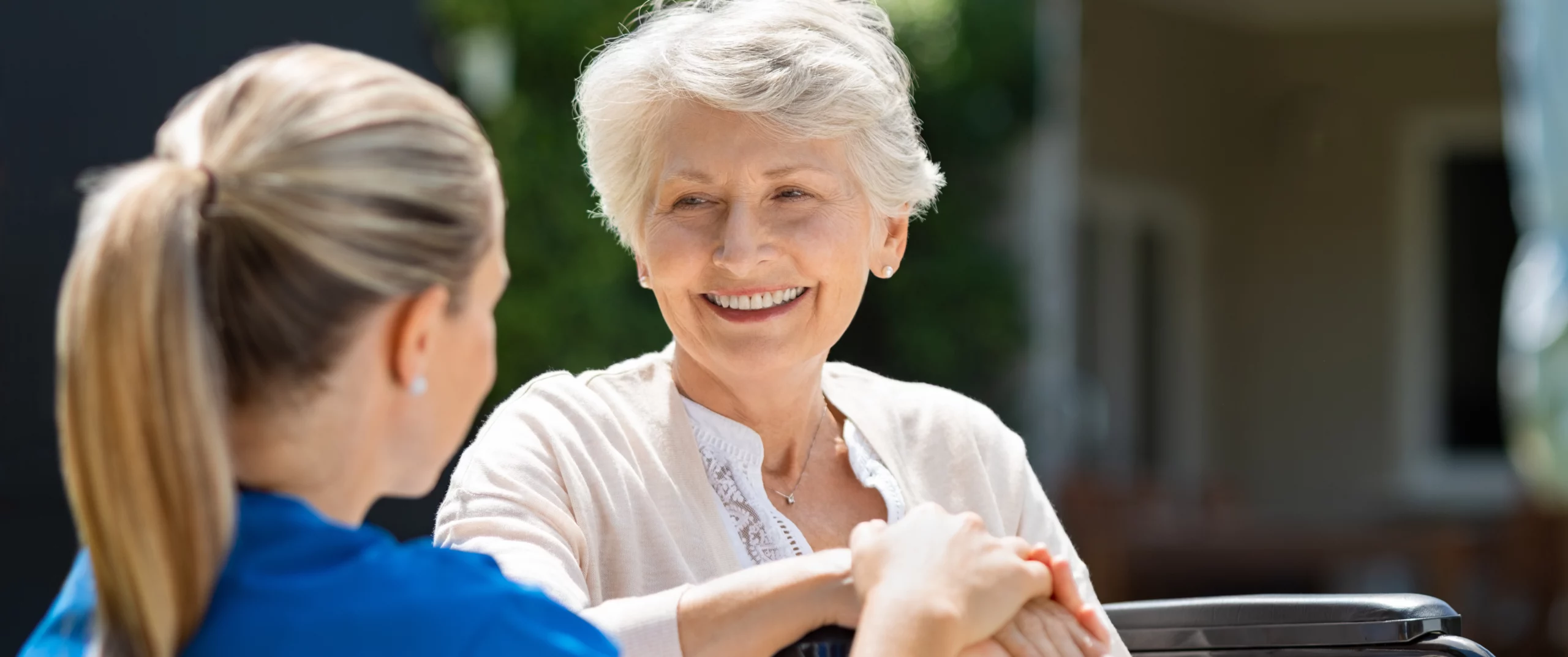 Elderly patient receiving care from a healthcare professional