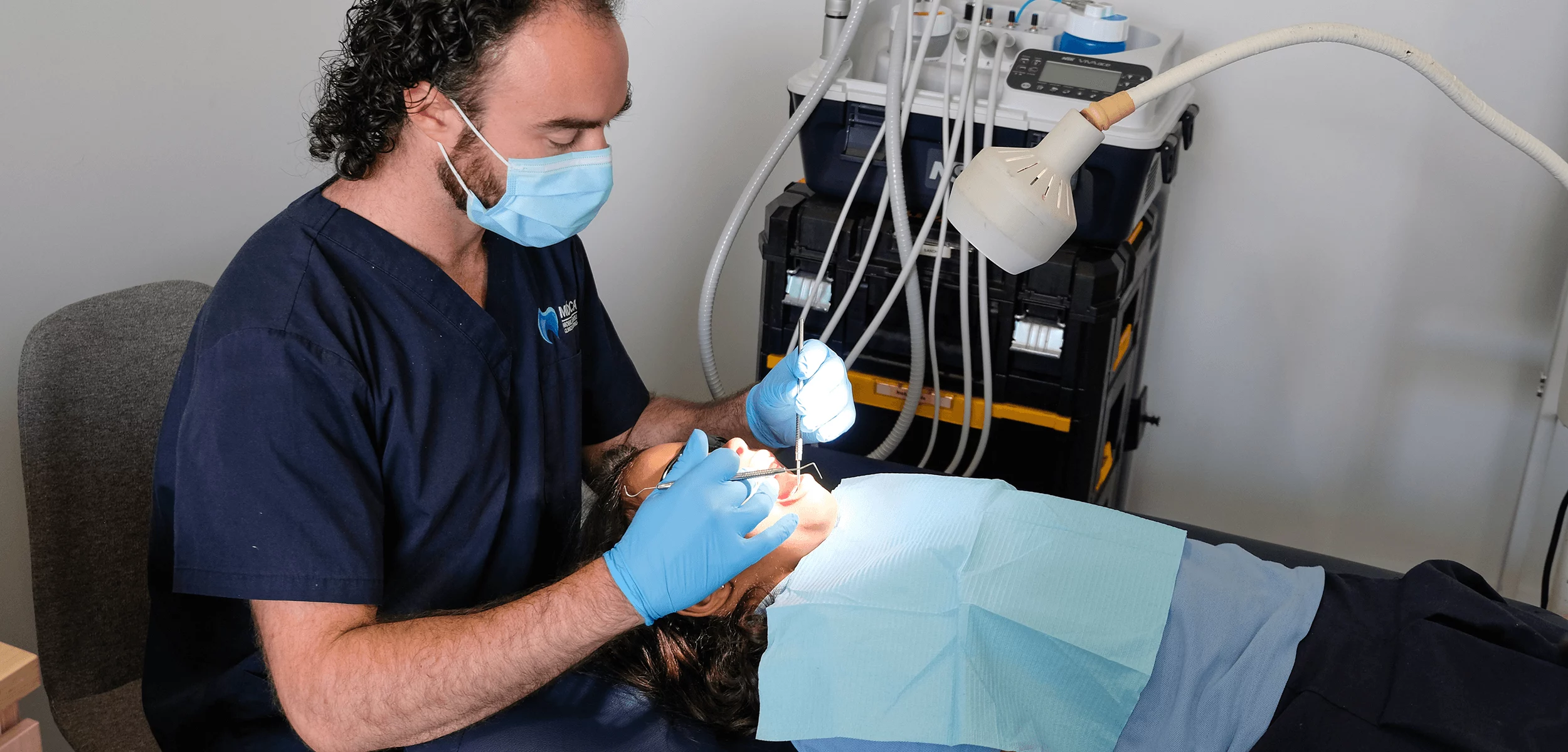 MDCA dentist performing a dental examination on a patient