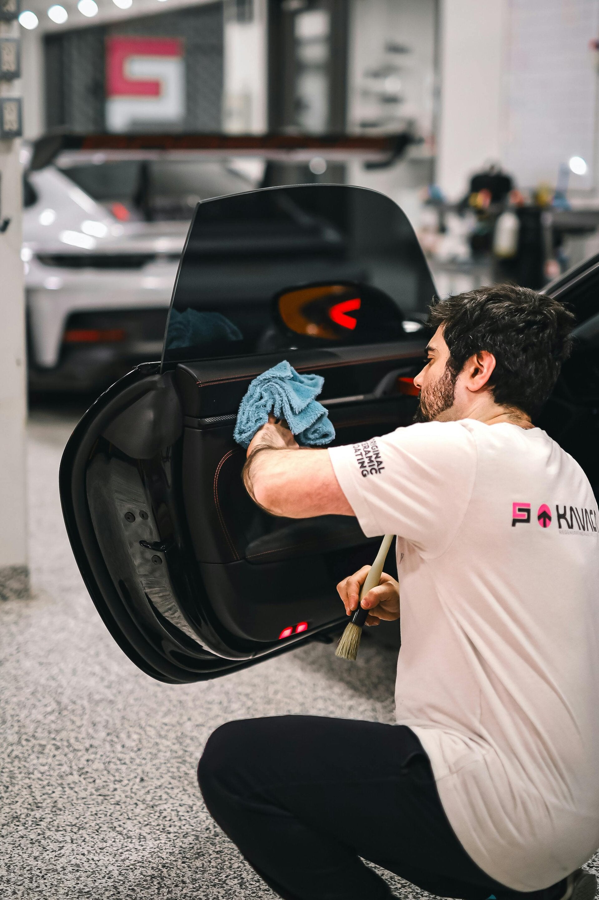 Technician installing a new front windshield on a vehicle