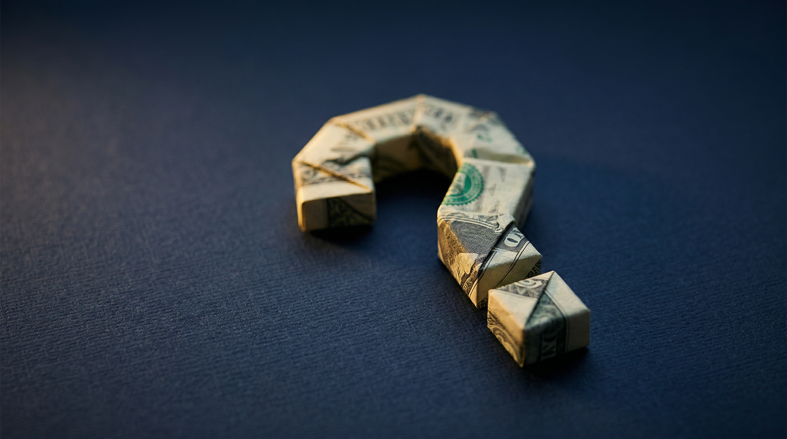 Dollar bill folded into a question mark, representing the myth of cheap SEO