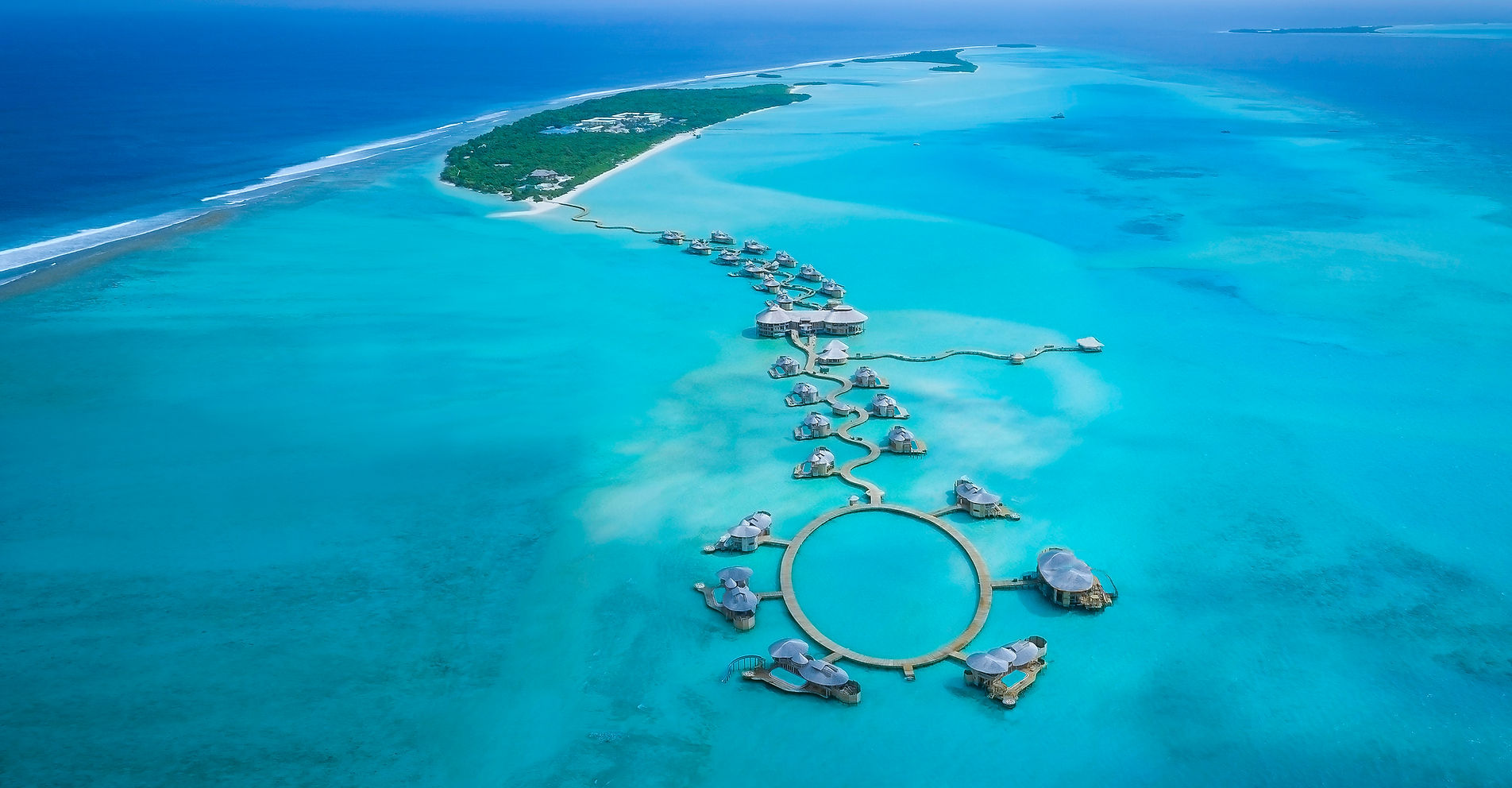 Aerial view of Soneva Jani overwater villas in the Noonu Atoll lagoon