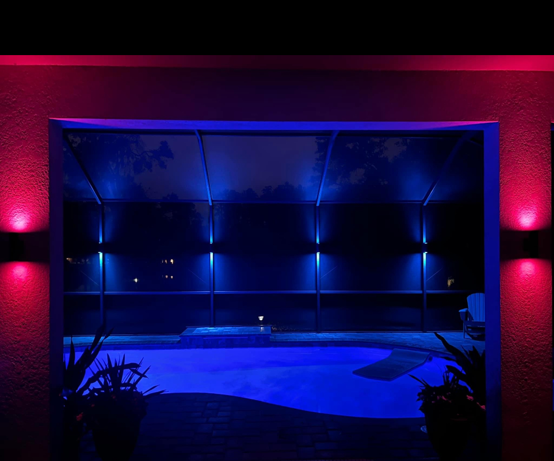 Pool cage lighting installation with dramatic LED accent lights in screened outdoor enclosure