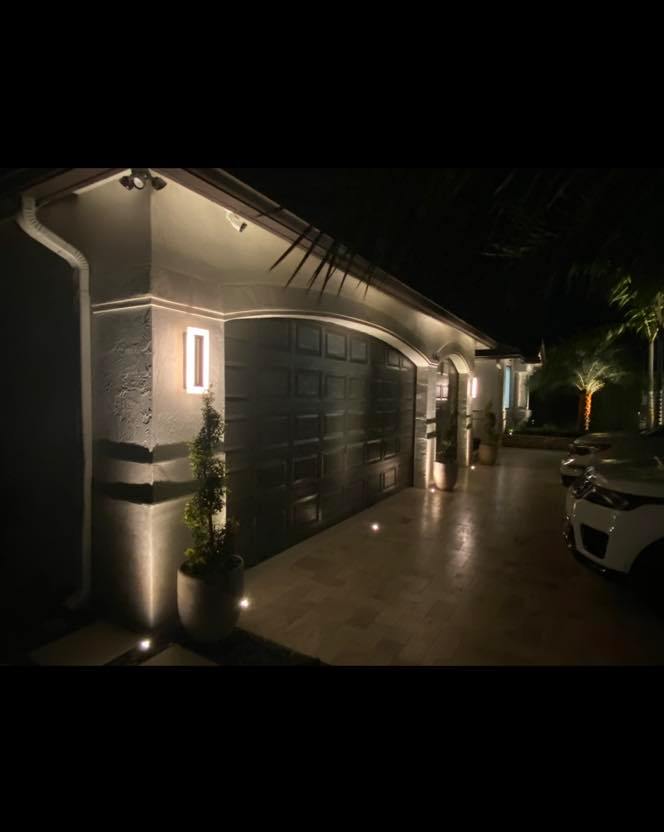 Residential exterior night lighting with warm LED uplighting on home facade
