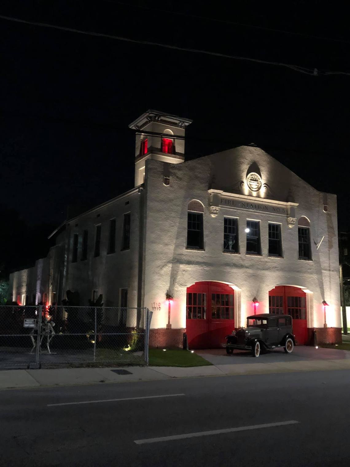 Historic building exterior with professional architectural uplighting highlighting stucco facade