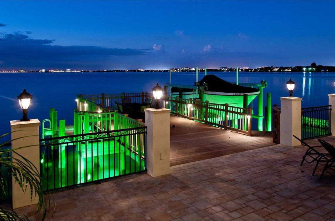 Dock and waterfront property with professional LED lighting installation along pier