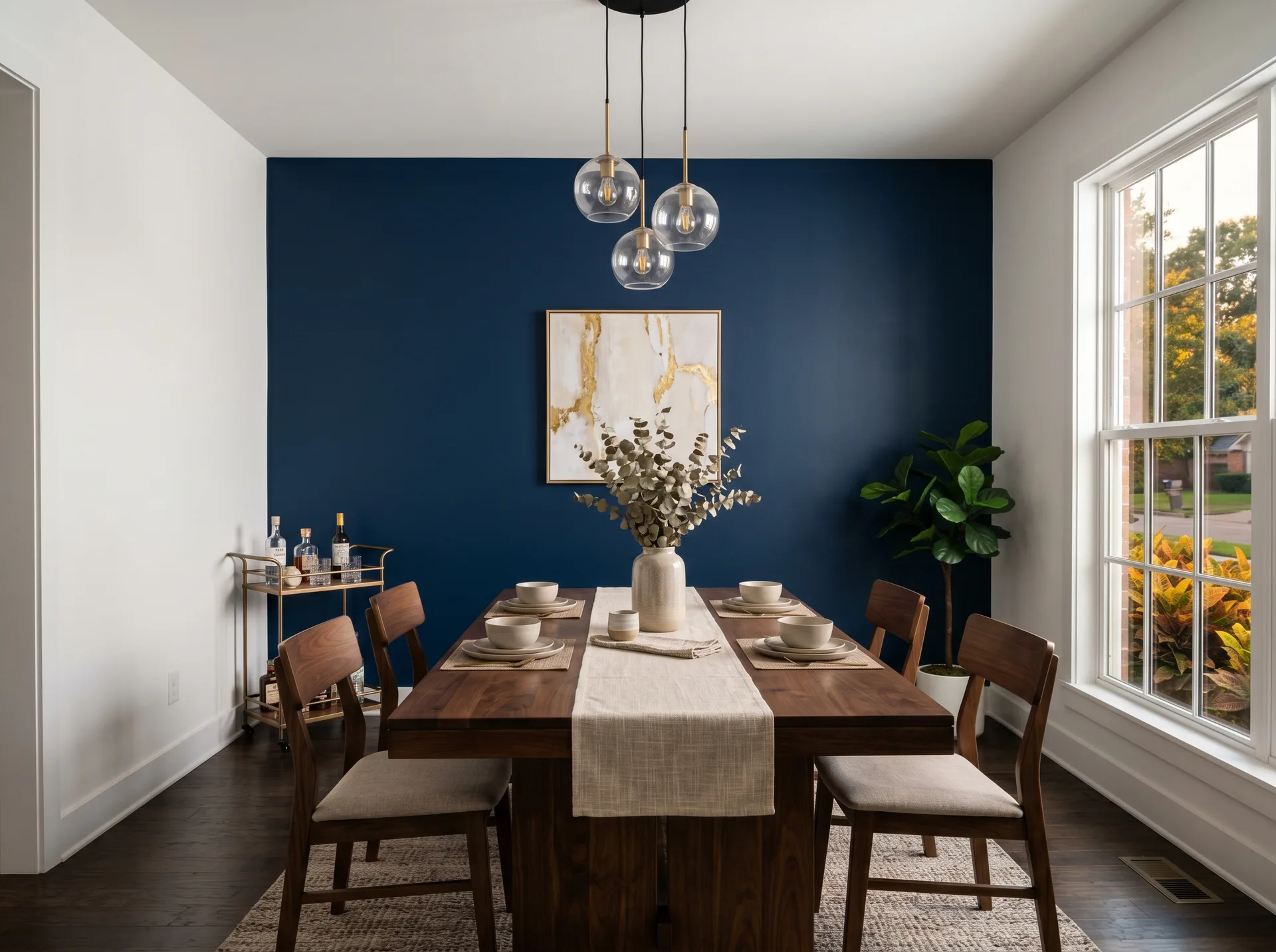 Elegant dining room with deep navy blue accent wall and white trim