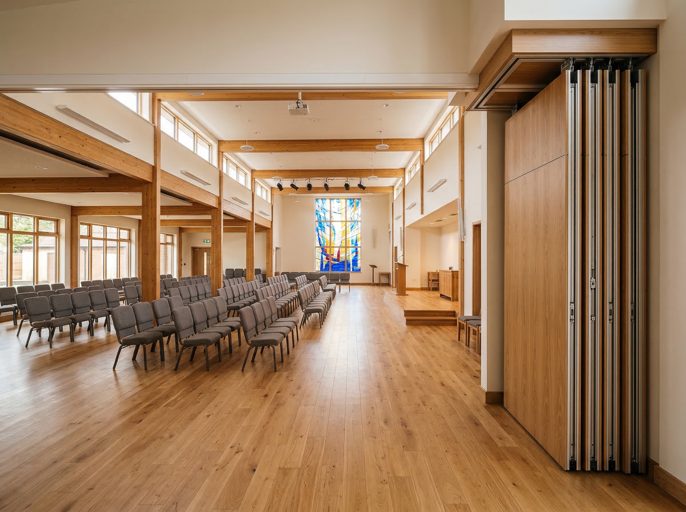 MG100 movable acoustic wall in open position at church, panels stacked to the side revealing full open-plan space